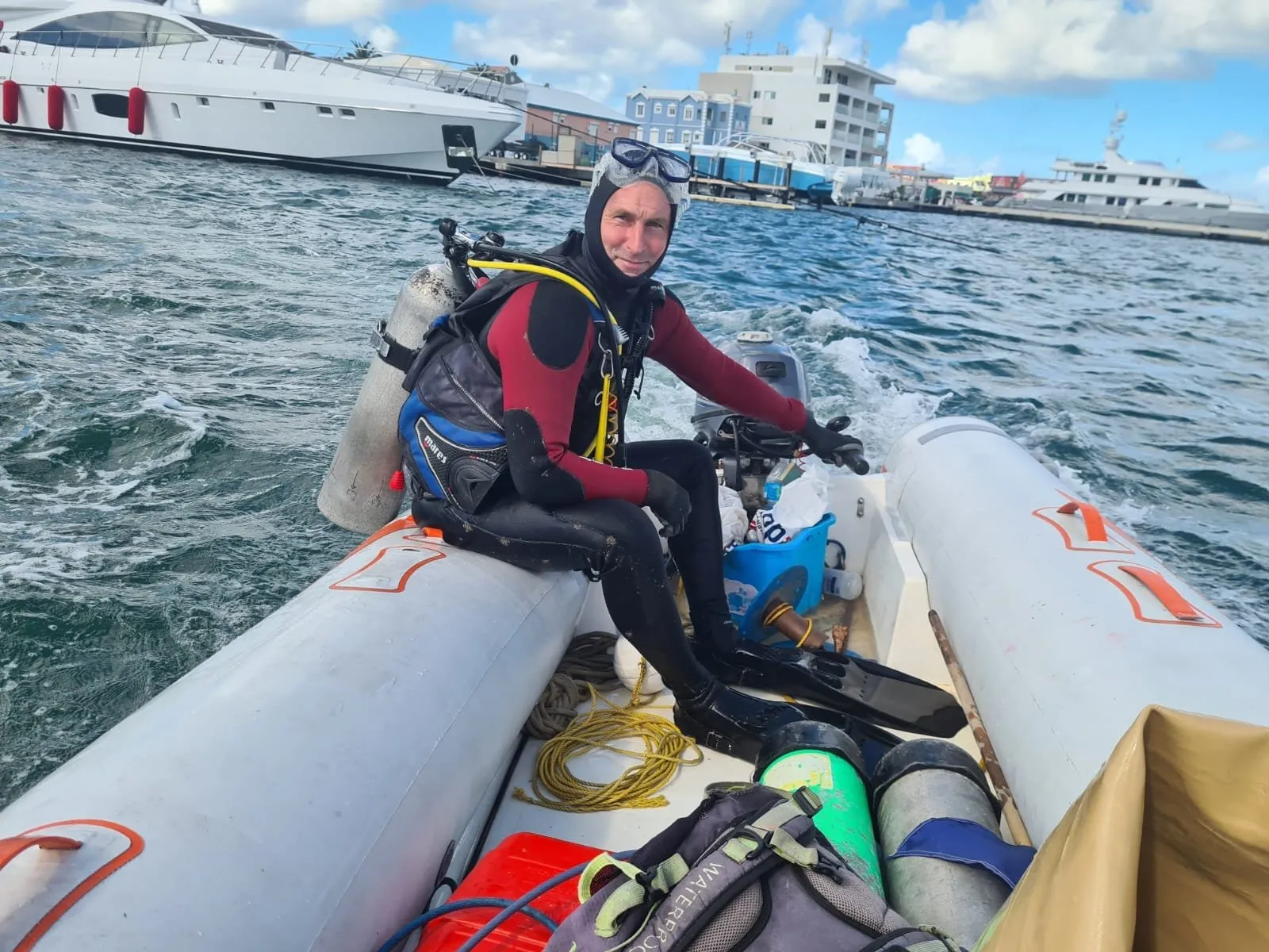 Graham Roebert of Cylipso Diving kitted up in a dive tender on the water in Sint Maarten