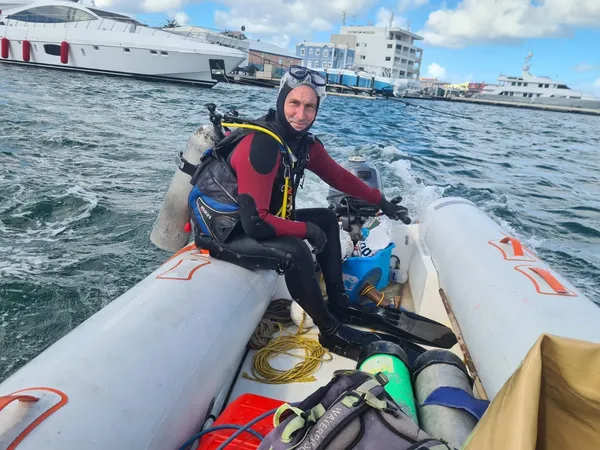 Graham Roebert of Cylipso Diving kitted up in a dive tender on the water in Sint Maarten