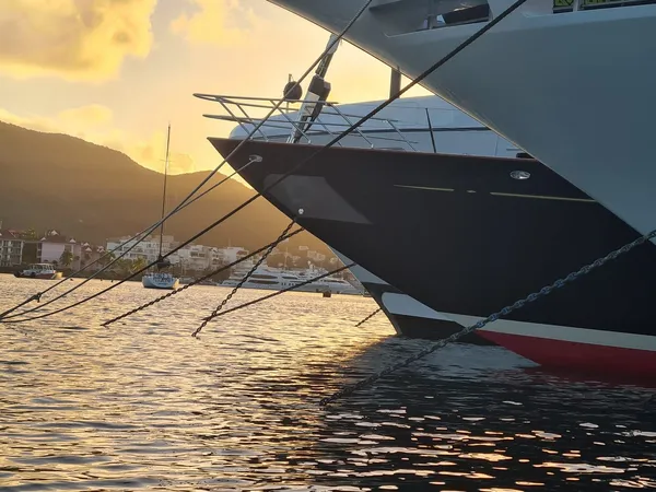 Superyacht bow and mooring lines at sunset in Simpson Bay, Sint Maarten
